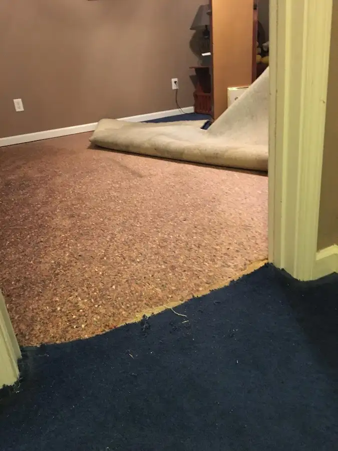 Carpet pad removal revealing water damage during Drying & Dehumidification in Caddo Mills