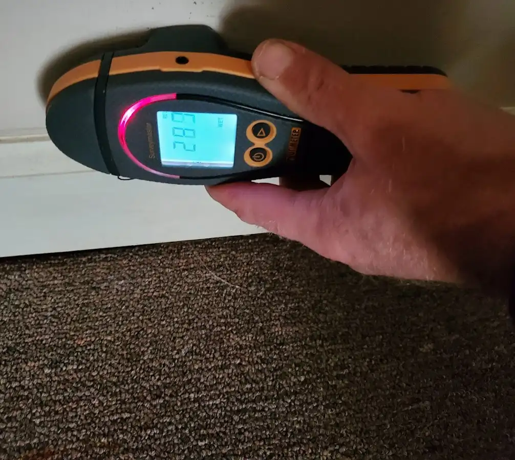 Moisture detection at baseboard during Storm Damage Restoration in Caddo Mills